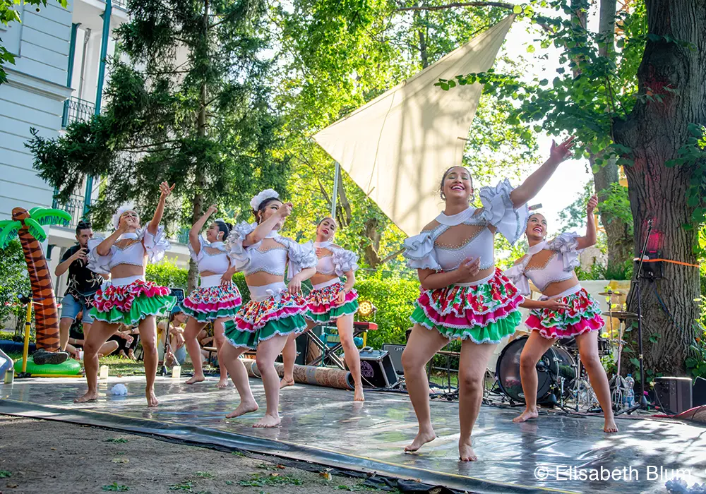 Group of female dancers performaning a traditional south american dance on stage